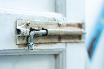 old metal latch is stained white color from door painting