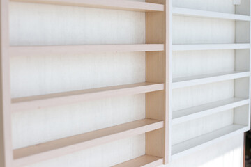 White Wooden Shelf on a Wall in Light Room.