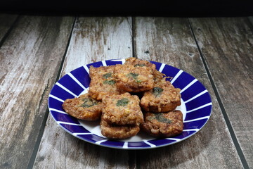 Traditional deep fried minced pork toast or pork bun on the plate. Famous Thai ancient snack in party or ceremony. Bread topping with marinated pork menu. 