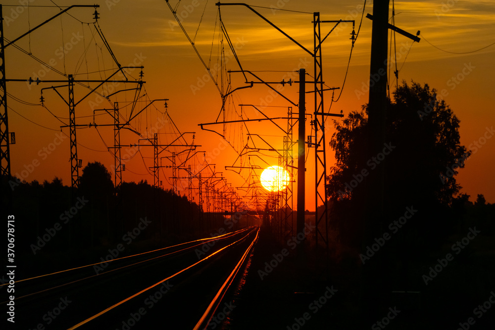 Wall mural railway in the rays of the setting sun