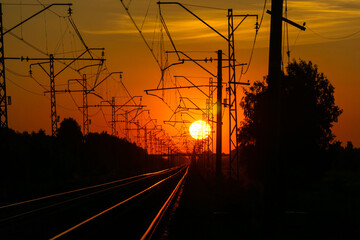 railway in the rays of the setting sun