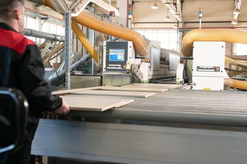 Huge working machine with chipboard on factory