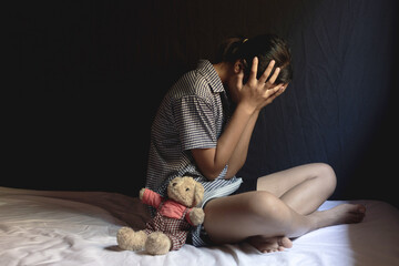 Sad girl sitting in room. human trafficking concept.