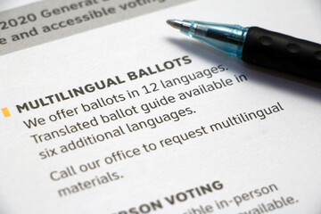 Closeup paper with 'Multilingual Ballots' info with pen