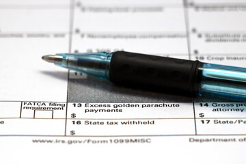 Closeup 'Excess Golden Parachute Payments' on 1099MISC tax form with pen