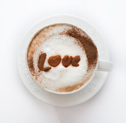 White Cup of cappuccino with cinnamon pattern on a white background, top view