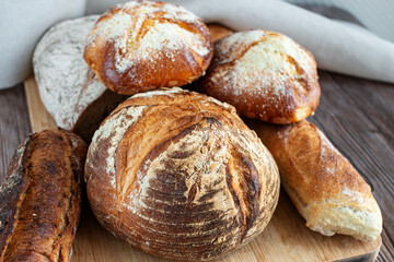 Range of baked bread on wooden table background