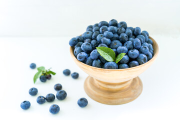 Blueberries on the table in a wooden cup