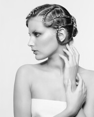 Black and white portrait in high key tone female with creative hairdo braids