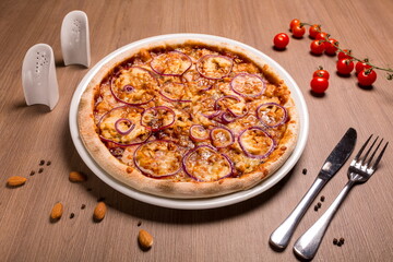 Barbecue pizza thin cake, BBQ sauce, chicken fillet, bacon, mushrooms, marinated onions, mozzarella, basil