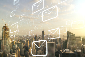 Double exposure of abstract virtual postal envelopes hologram on New York city skyscrapers background. Electronic mail and spam concept