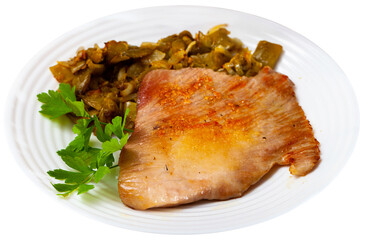 Close-up fried pork meat chops with stewed beans at plate. Isolated over white background