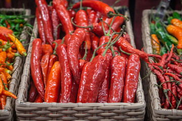 Basket with red and green chilli pepper in the shop