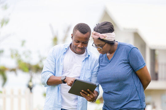 Cheerful african american couple with digital tablet, happiness family concepts