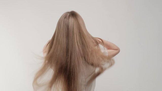 Closeup waving brunette hair in studio on a white background.