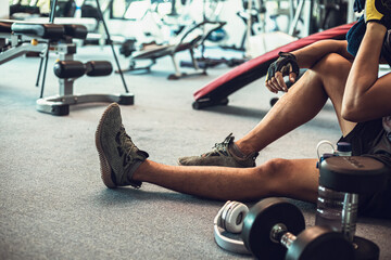 man hold towel  at gym taking a break from workout.