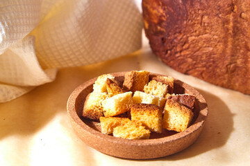 Square toasted pieces of homemade delicious rusk, hardtack, Dryasdust, zwieback and bread on a white tablecloth.
