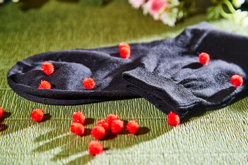 Several pairs of new male cotton socks on a green surface and flowers background. The concept of coziness and comfort. Gift to a man.