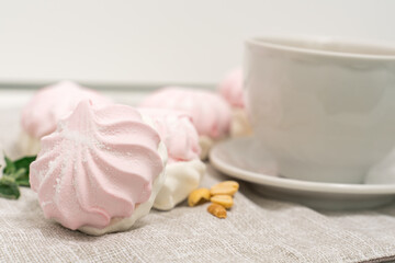 sweet tender marshmallows and a cup of tea on the table