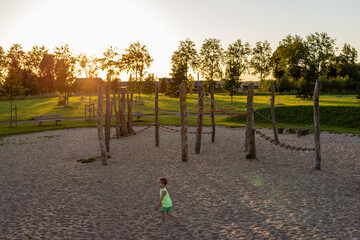 Boy running through the playground.