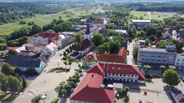 Aerial View of the  Holy Trinity Lutheran Church in Tukums, Latvia. Golden Cock Statue on the Top of Tower. Tukums City Park on the  the Background. Sunny Summer Day.
