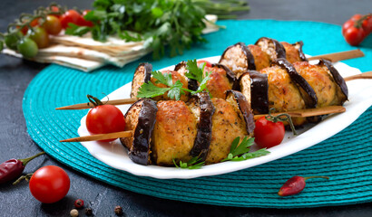 Griled meatballs with eggplant on skewers. Chicken kebab with vegetables. Diet meat dish.
