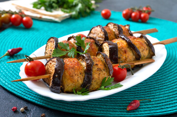 Griled meatballs with eggplant on skewers. Chicken kebab with vegetables. Diet meat dish.