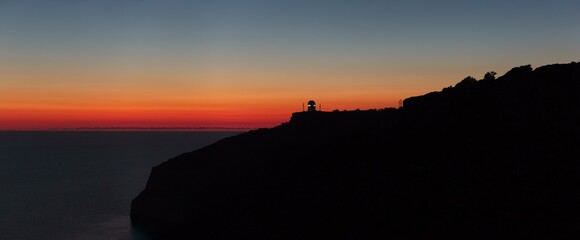 A beautiful sunset over calm Mediterranean waters at Dingli Cliffs in Malta