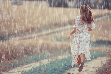 rain in summer adult girl in a dress field, happiness summer mood freedom