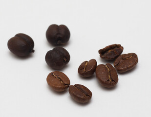 Obraz premium Isolated coffee beans at white backdrop. Morning taste. Flavor for Wake up. Energy drink. Make your coffee. Freshness aromatic beverage.