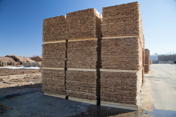 A pallet of boards in an industrial sawmill warehouse