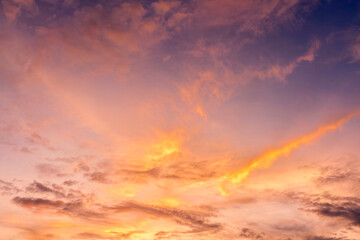 Fototapeta na wymiar Fluffy sunset clouds flying on blue sky background