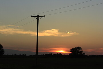 power lines at sunset in Kansas west of Sterling Kansas USA.