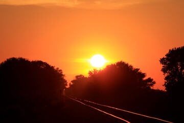 Sunset in the country with tree's sky and railroad tracks in Kansas.