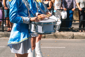 Young girls drummer at the parade. Street performance. Majorettes and marching band