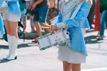 Young girls drummer at the parade. Street performance. Majorettes and marching band
