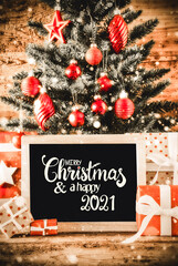 English Calligraphy Merry Christmas And A Happy 2021. Bright Christmas Tree With Gifts, Red Ball Ornament And Sowflakes