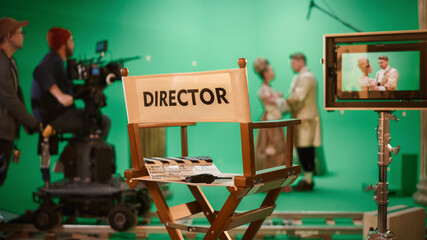 On Film Studio Set Focus on Empty Director's Chair. In the Background Professional Crew Shooting...