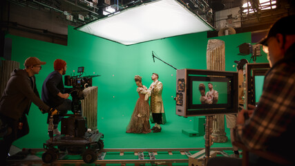 On Big Film Studio Professional Crew Shooting Period Costume Drama Movie. On Set: Director Controls...