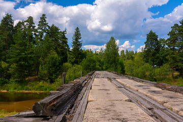 Old bridge over the river in the forest