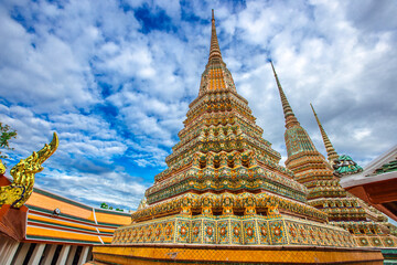 Fototapeta premium background of important religious attractions in Bangkok (Wat Phra Chetuphon (Wat Pho - reclining Buddha), a large pagoda and beautiful sculptural art give future generations to explore its history