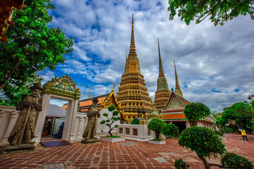 Fototapeta premium background of important religious attractions in Bangkok (Wat Phra Chetuphon (Wat Pho - reclining Buddha), a large pagoda and beautiful sculptural art give future generations to explore its history