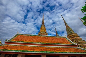 Fototapeta premium background of important religious attractions in Bangkok (Wat Phra Chetuphon (Wat Pho - reclining Buddha), a large pagoda and beautiful sculptural art give future generations to explore its history
