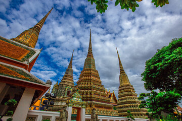 Fototapeta premium background of important religious attractions in Bangkok (Wat Phra Chetuphon (Wat Pho - reclining Buddha), a large pagoda and beautiful sculptural art give future generations to explore its history
