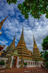 Fototapeta premium background of important religious attractions in Bangkok (Wat Phra Chetuphon (Wat Pho - reclining Buddha), a large pagoda and beautiful sculptural art give future generations to explore its history