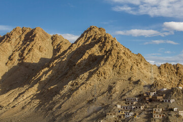 Fototapeta na wymiar simple houses on the ridge of a sandy mountain