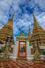 Fototapeta premium background of important religious attractions in Bangkok (Wat Phra Chetuphon (Wat Pho - reclining Buddha), a large pagoda and beautiful sculptural art give future generations to explore its history