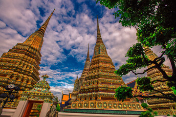 Fototapeta premium background of important religious attractions in Bangkok (Wat Phra Chetuphon (Wat Pho - reclining Buddha), a large pagoda and beautiful sculptural art give future generations to explore its history