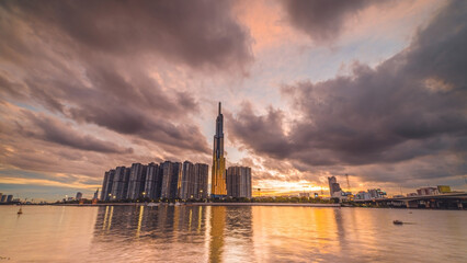 Sunset at Landmark 81 is a super tall skyscraper in center Ho Chi Minh City, Vietnam and Saigon bridge with development buildings, energy power infrastructure.