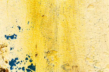 Great colorful background or texture. Abstract concrete is aged with cracks, scratches and remnants of old paint in different shades. Rough concrete surface
